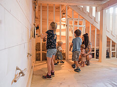 Children play in Olga's cowshed on the Rinderberg.