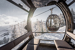 View of the snow-covered winter landscape from a gondola.