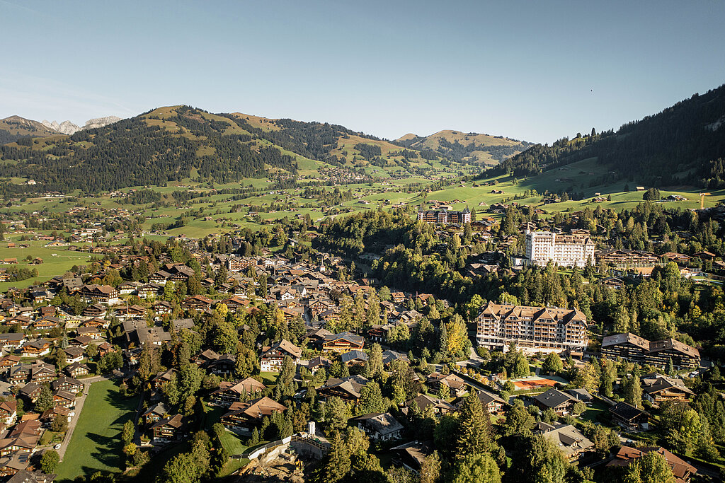 <p>Aerial view of the village of Gstaad in summer with a cloudless sky.</p>