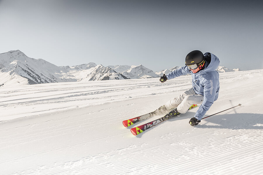 Former ski racer Mike von Grünigen rounds a curve on a freshly groomed piste.