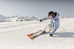 Former ski racer Mike von Grünigen rounds a curve on a freshly groomed piste.