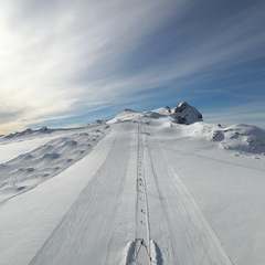 Aerial view of the Dôme T-bar lift on Glacier3000 with the Diablerets summit in the background.