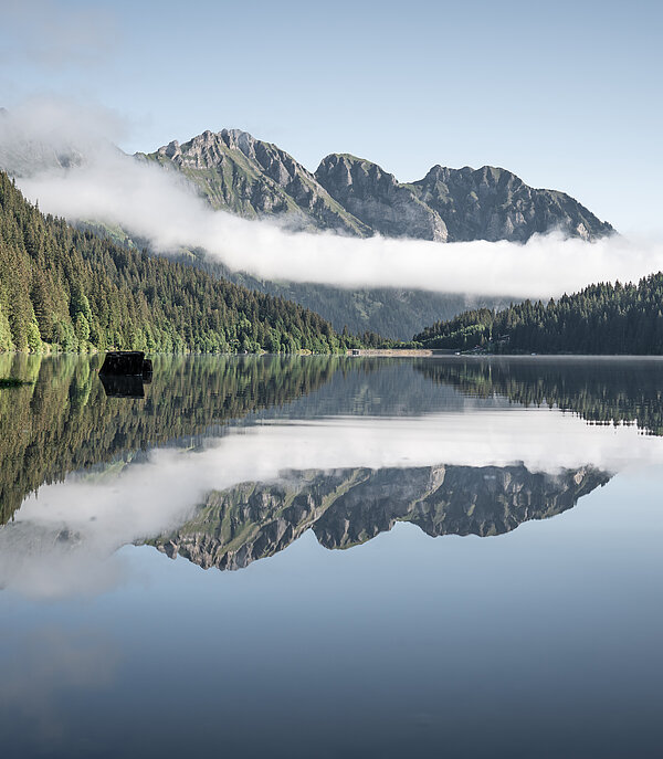 Smooth Arnensee in autumn with view of Staldenfluh and mirror of the mountains in the lake