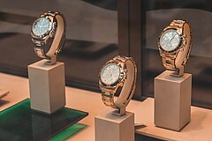 Shop window with three watches.