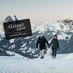 Couple walking on a snow-covered winter hiking trail
