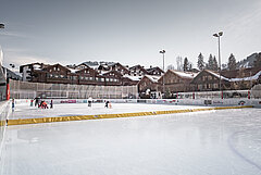 The Gstaad ice rink is located in the middle of the village surrounded by cosy chalets