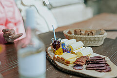 Alpine specialities like bread, sausage and cheese are laid out.